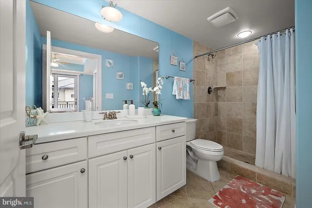 a view of a workspace with furniture and floor to ceiling window