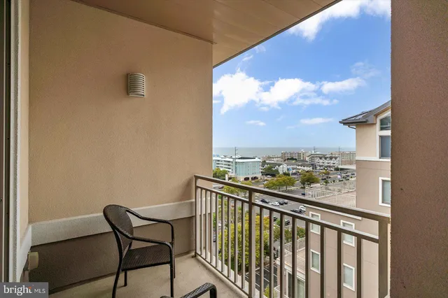 a view of a tall building next to a road