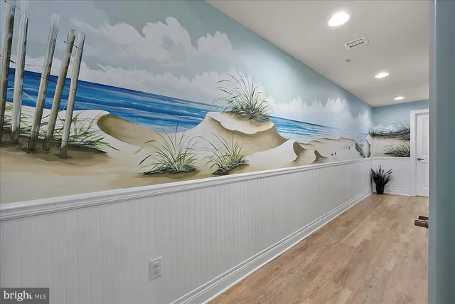 a living room with furniture a fireplace and a large window