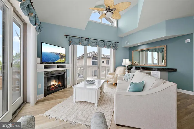 a living room with furniture and a floor to ceiling window