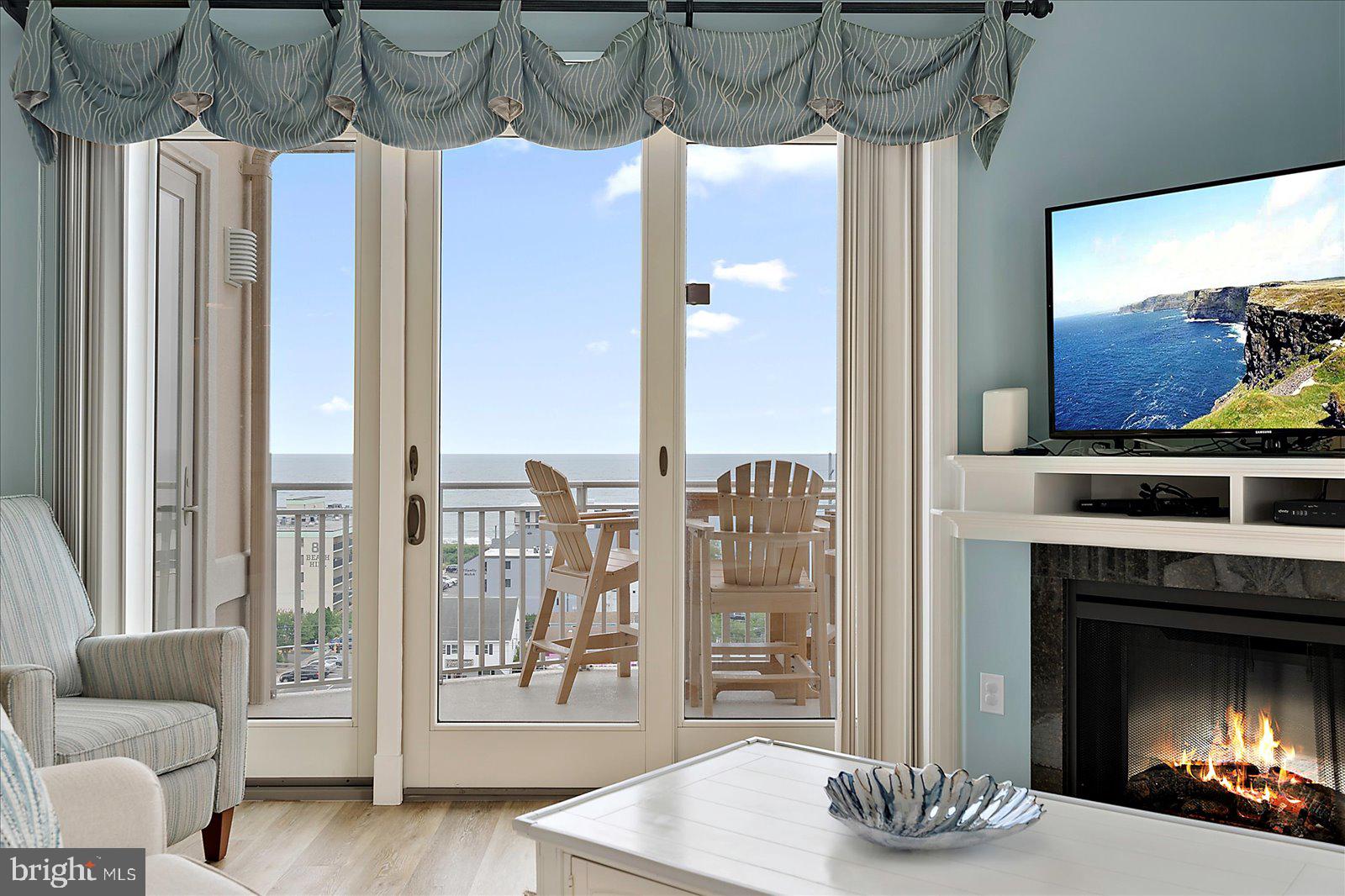 121 81st Street, Unit 907 Ocean City, MD 21842 - Photo 10 of 73 a living room with furniture and a fireplace