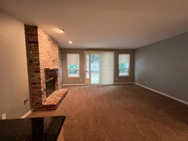 a kitchen with granite countertop sink and cabinets