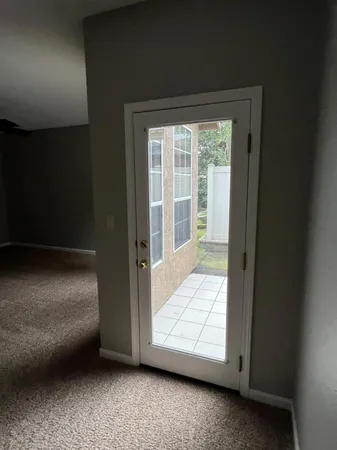 a view of a livingroom with furniture and floor to ceiling window