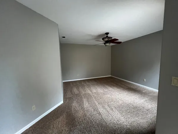 a view of walk in closet with empty racks