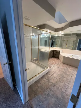 a large white kitchen with a sink and refrigerator