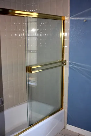 a bathroom with a glass shower door