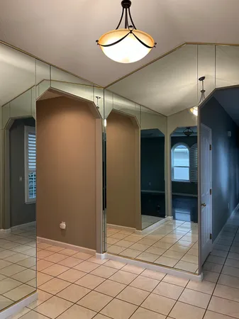 a view of a hallway with wooden shelves
