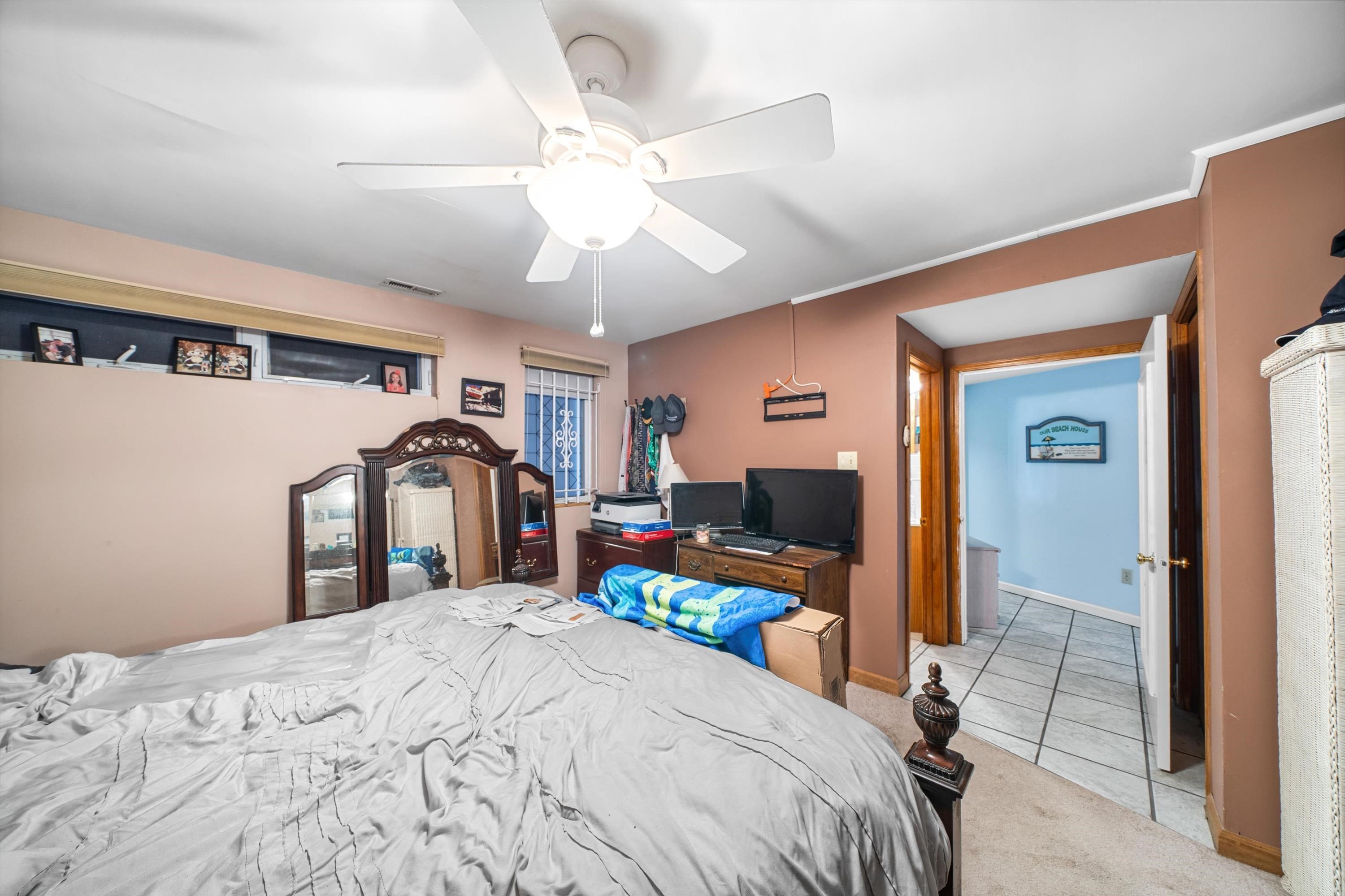 5105 Shawcrest Road, Unit 5105 Wildwood, NJ 08260 - Photo 14 of 31 a bedroom with a bed and a flat tv screen on dresser