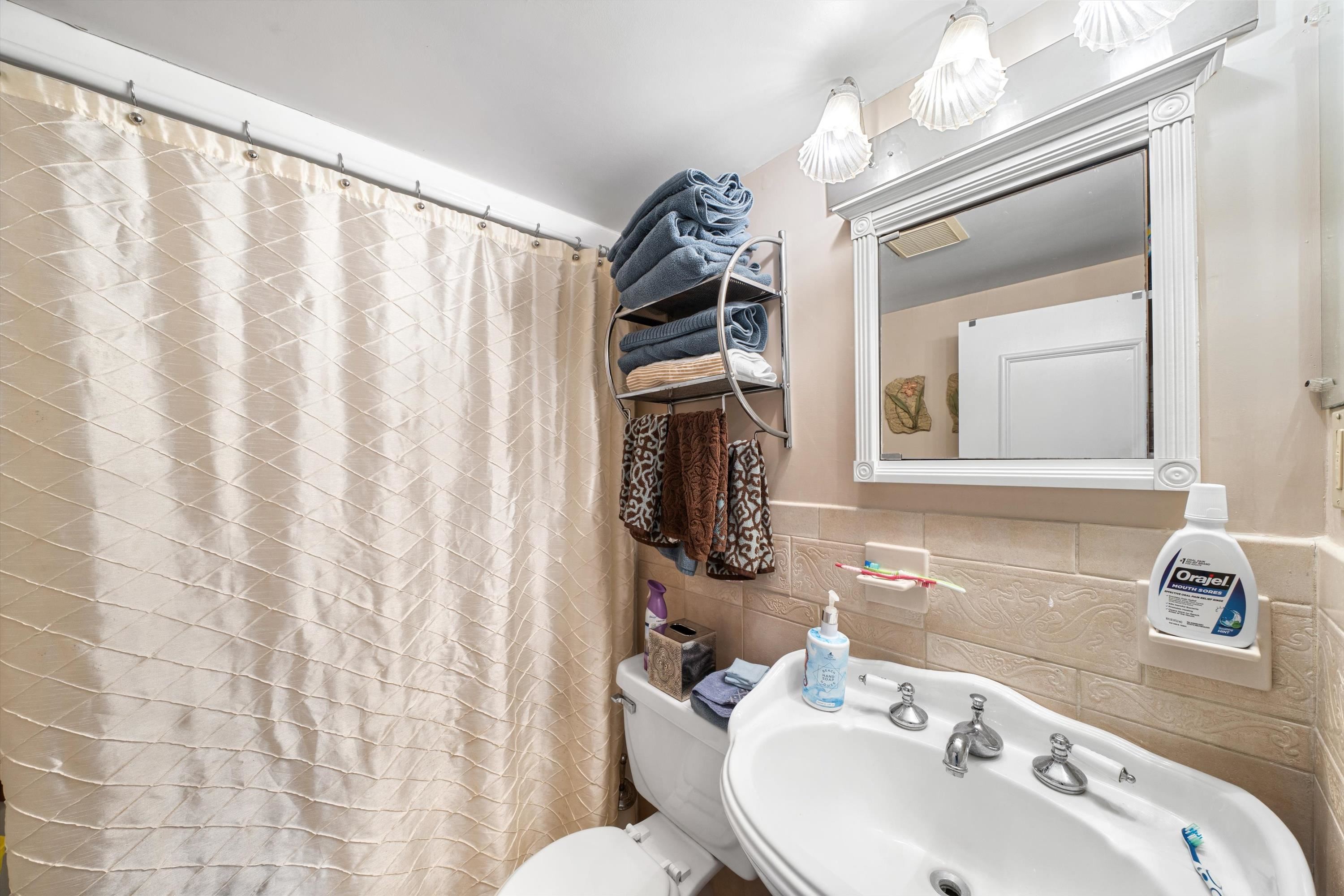 5105 Shawcrest Road, Unit 5105 Wildwood, NJ 08260 - Photo 15 of 31 a bathroom with a sink and a mirror