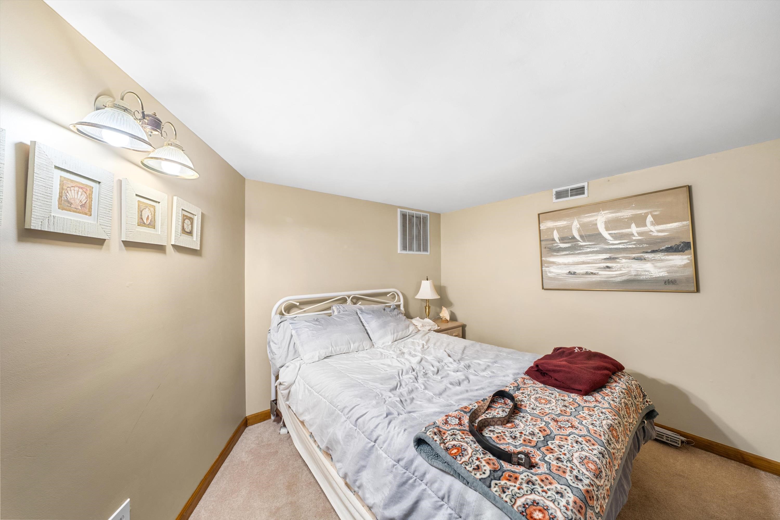 5105 Shawcrest Road, Unit 5105 Wildwood, NJ 08260 - Photo 17 of 31 a bedroom with a bed and painting on the wall