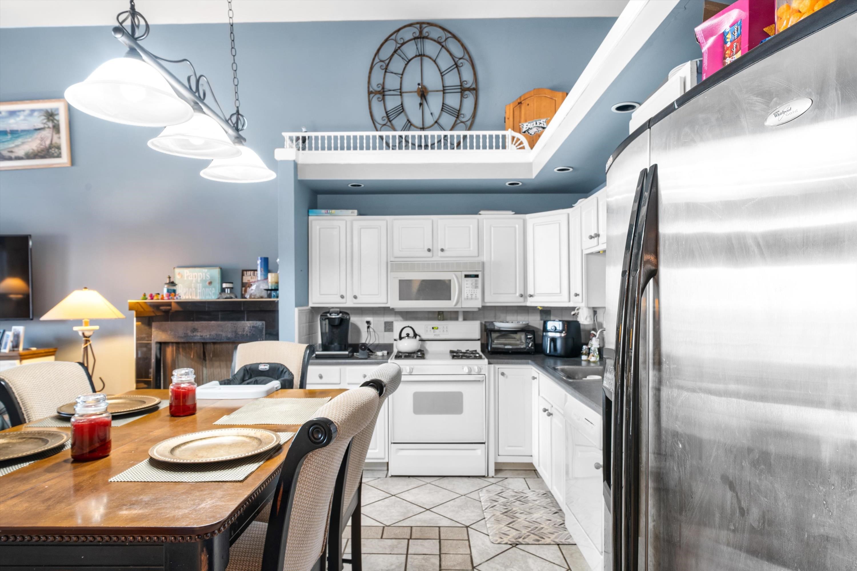 5105 Shawcrest Road, Unit 5105 Wildwood, NJ 08260 - Photo 20 of 31 a kitchen with a sink a stove and chairs