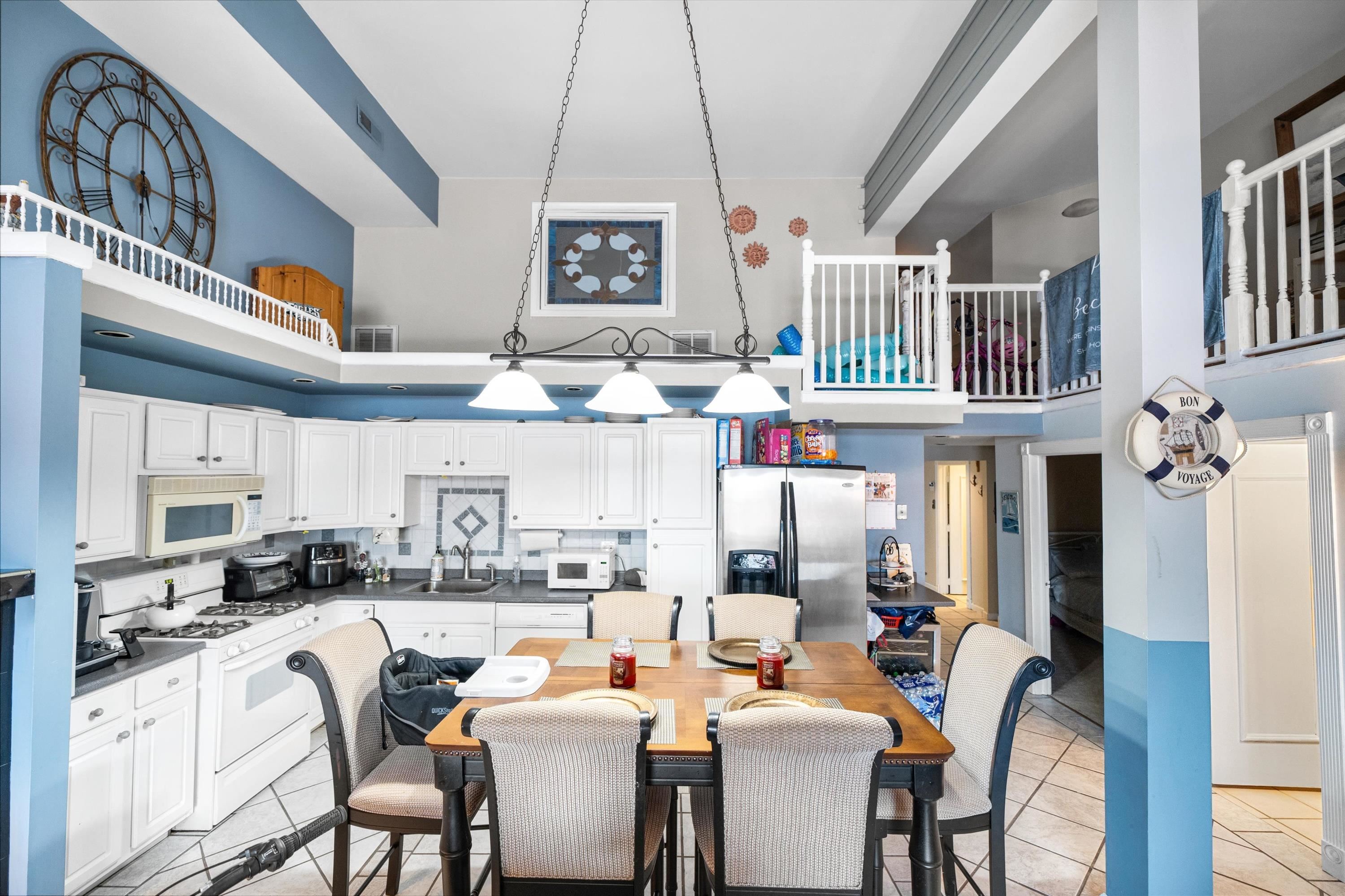 5105 Shawcrest Road, Unit 5105 Wildwood, NJ 08260 - Photo 22 of 31 a dinning room with stainless steel appliances kitchen island granite countertop furniture and a kitchen view