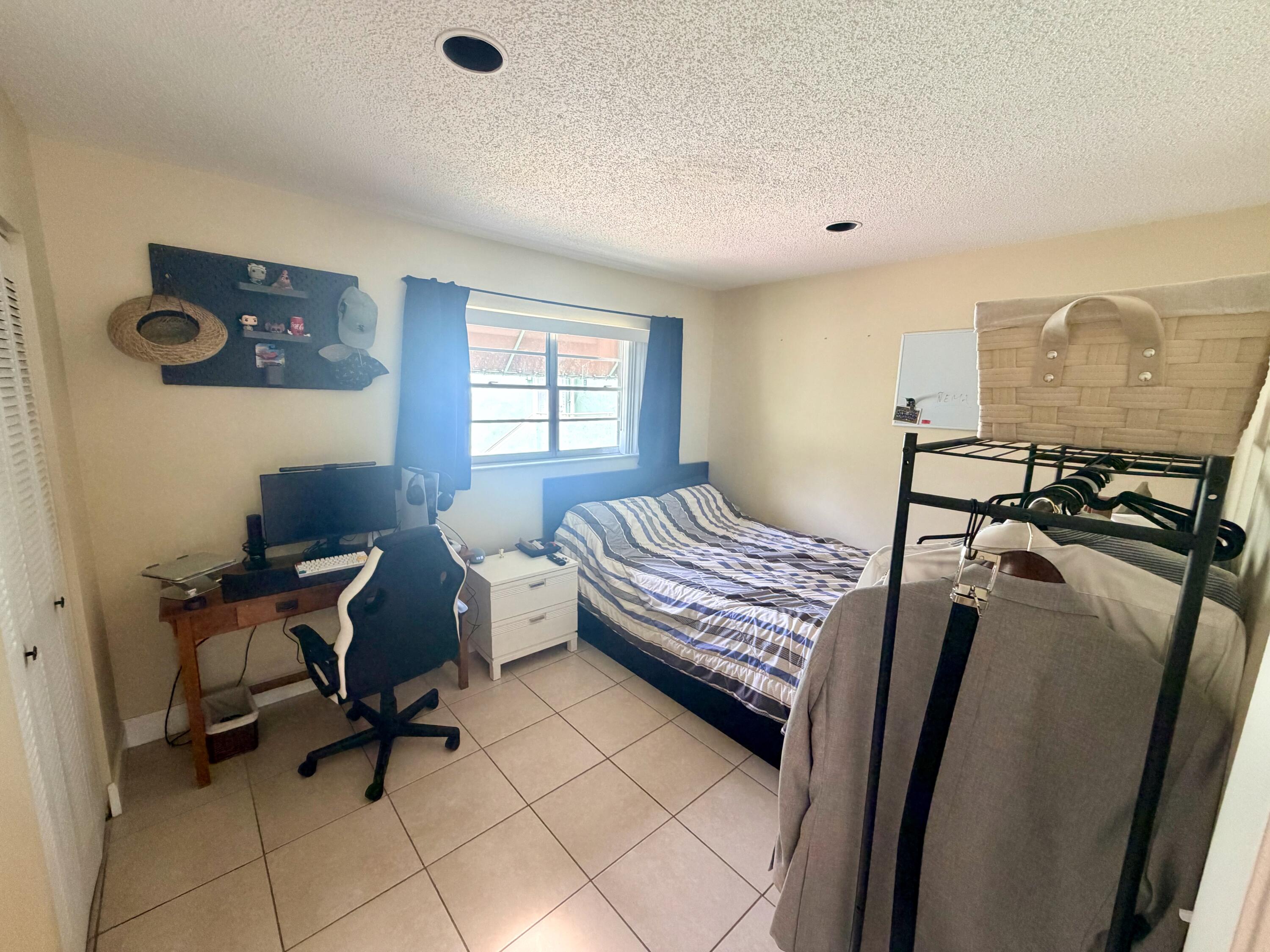 11071 Northwest 7th Street, Unit 104 Miami, FL 33172 - Photo 25 of 30 a bedroom with furniture and a window