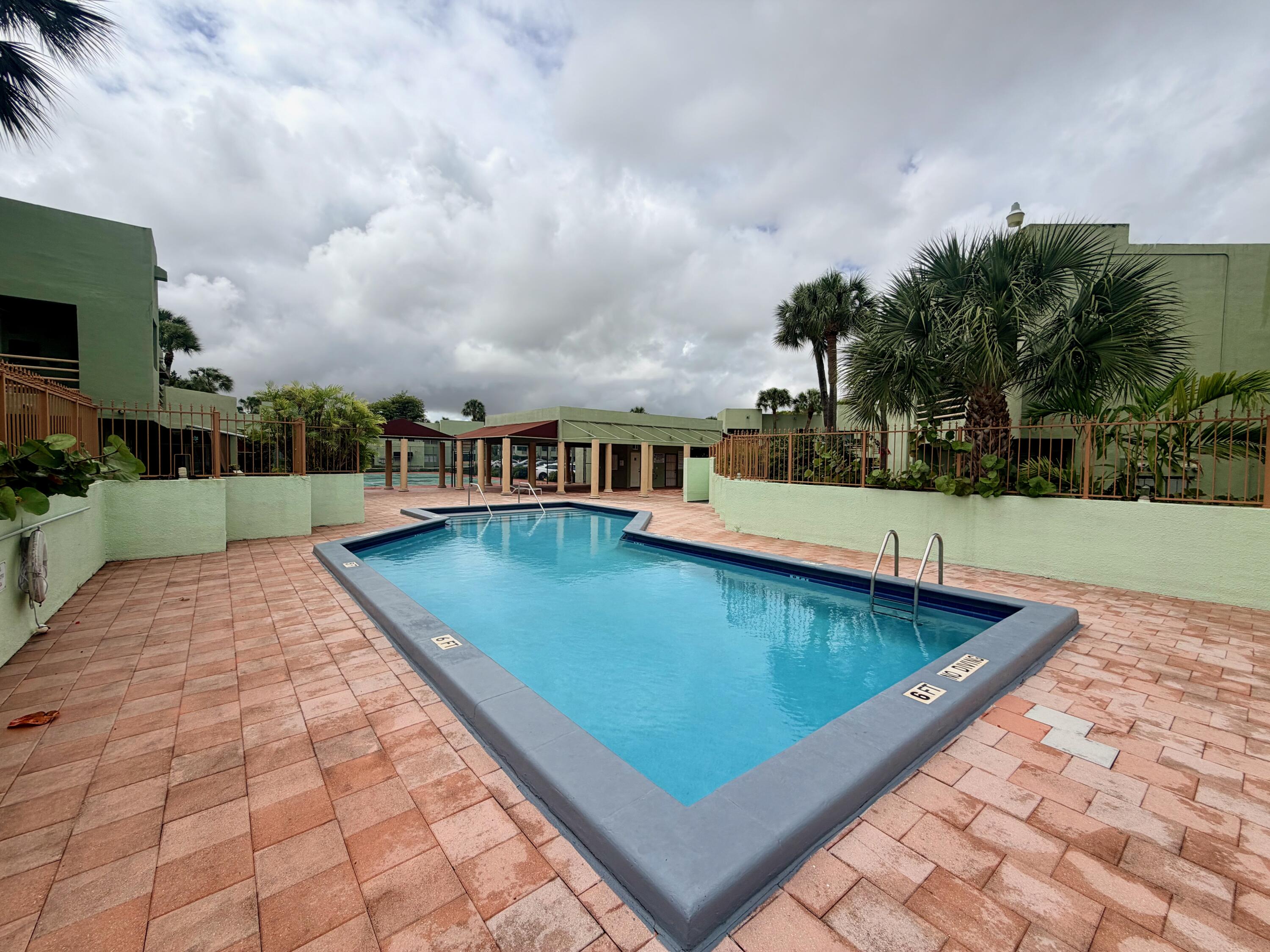 11071 Northwest 7th Street, Unit 104 Miami, FL 33172 - Photo 27 of 30 a view of a swimming pool with a yard