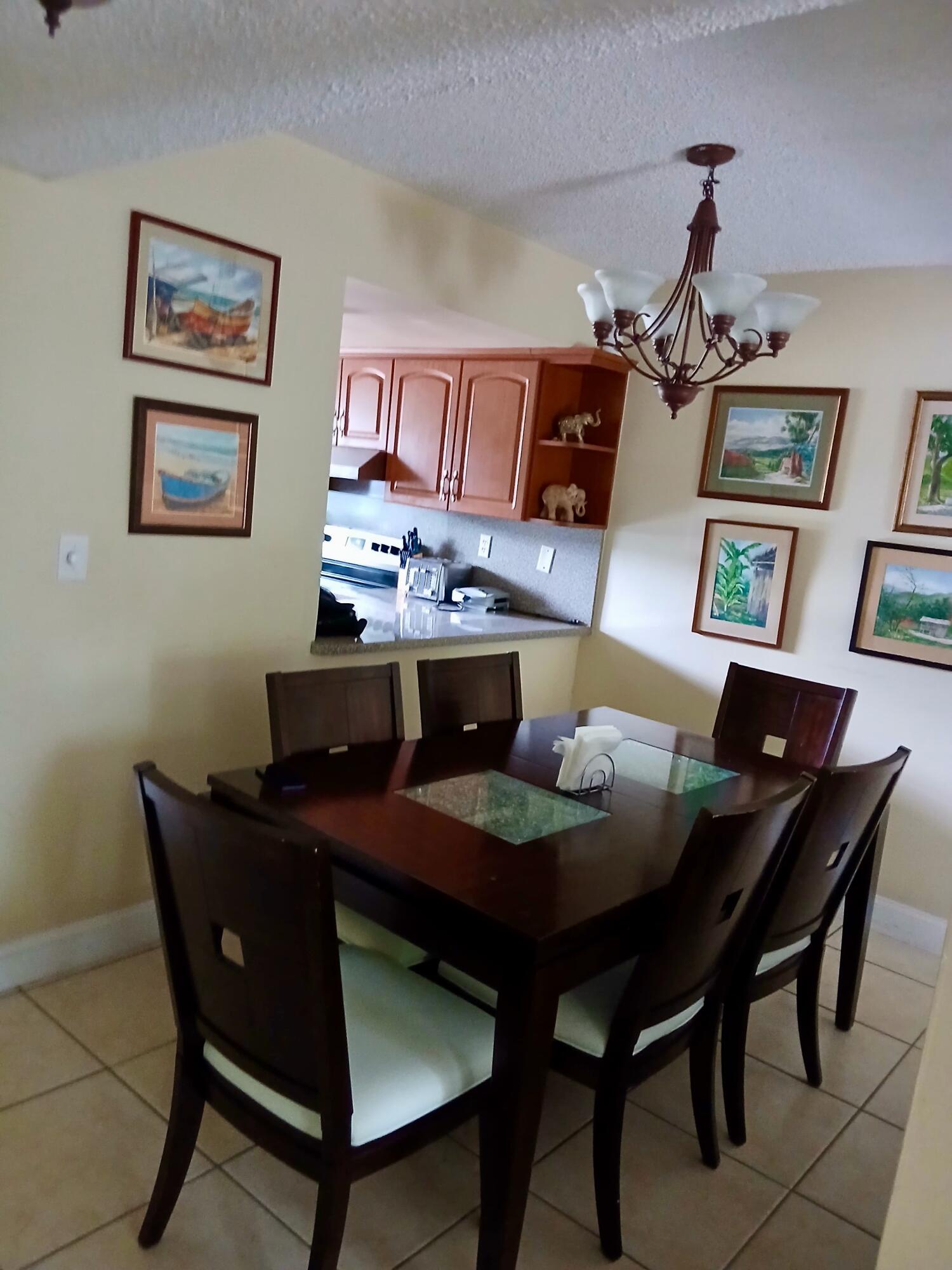 11071 Northwest 7th Street, Unit 104 Miami, FL 33172 - Photo 6 of 30 a dining room with a table and chairs