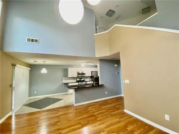 a view of kitchen and dining room with wooden floor