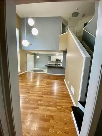 a view of a kitchen with a sink and wooden floor