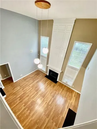 a view of an empty room and wooden floor