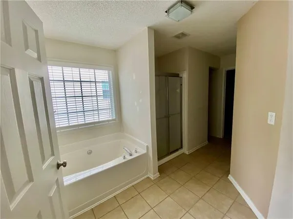 a bathroom with a bathtub and shower