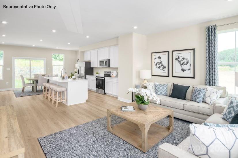 2182 Flicker Road, Unit 1036B Indian Land, SC 29707 - Photo 6 of 17 a living room with furniture and kitchen view
