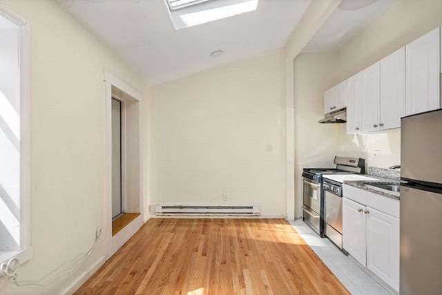 a kitchen with a stove a sink and a refrigerator