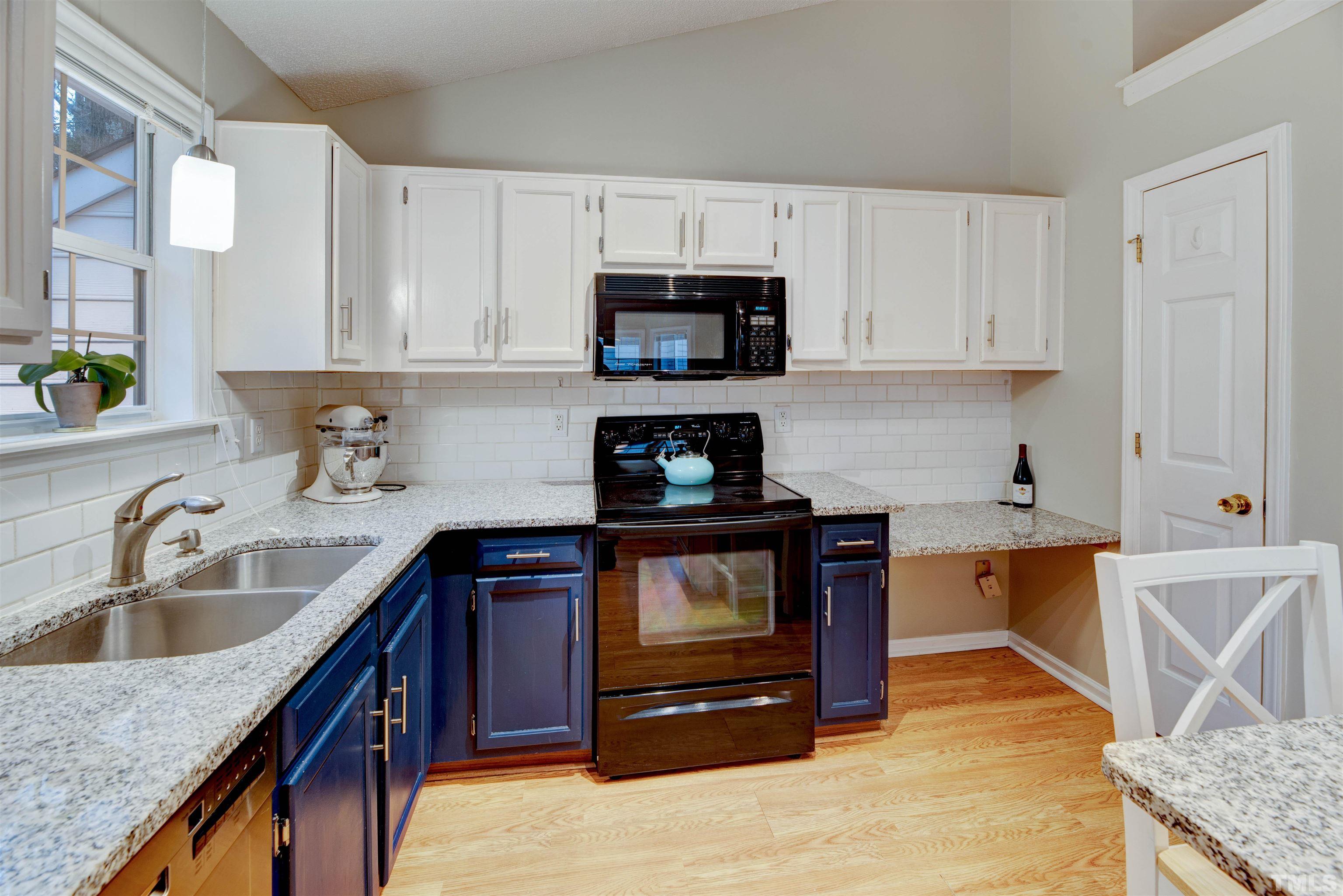 2305 Ruddy Road Raleigh, NC 27616 - Photo 17 of 37 a kitchen with stainless steel appliances granite countertop a sink stove and microwave