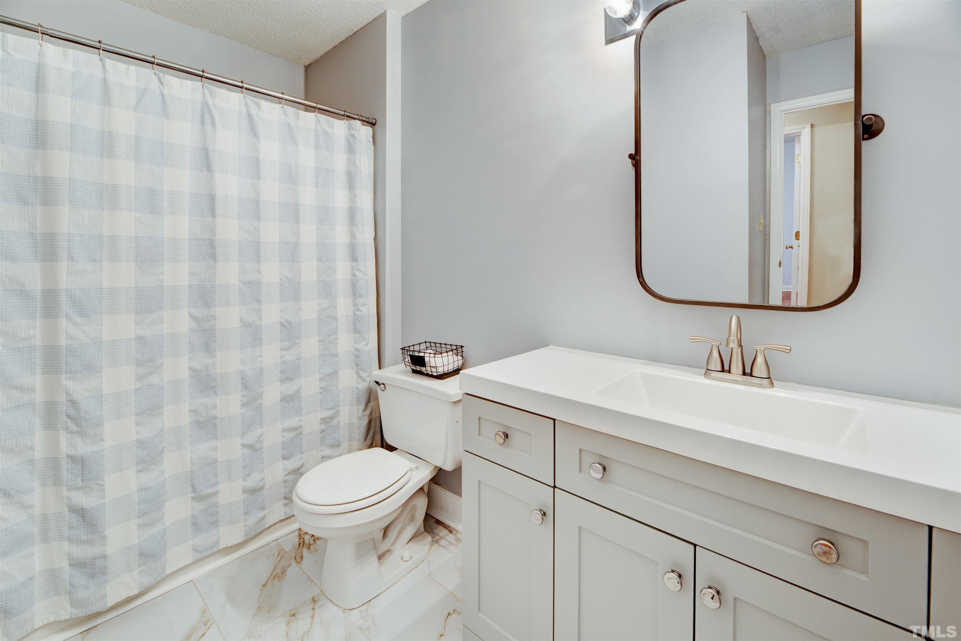 2305 Ruddy Road Raleigh, NC 27616 - Photo 25 of 37 a bathroom with a sink a toilet and a mirror