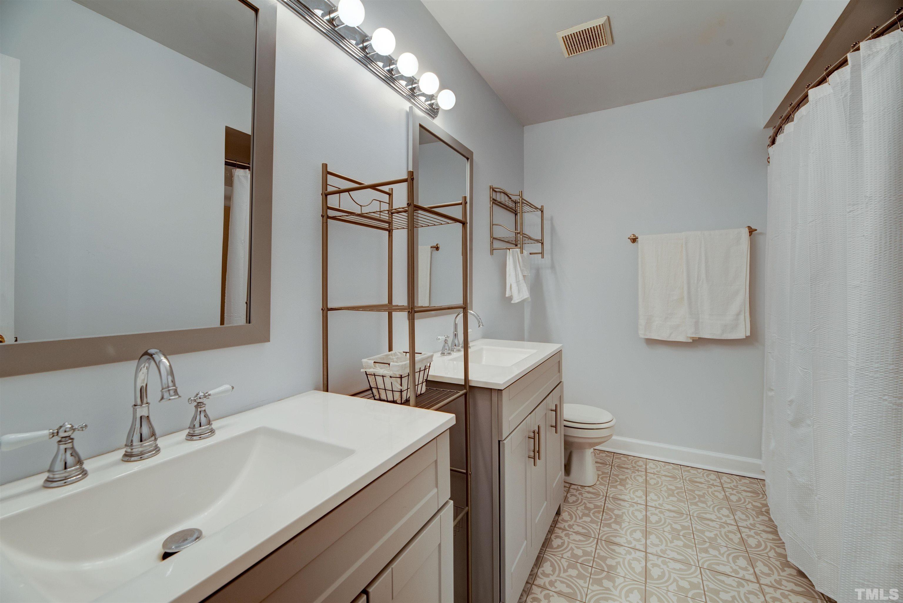 2305 Ruddy Road Raleigh, NC 27616 - Photo 32 of 37 a bathroom with a sink and a mirror