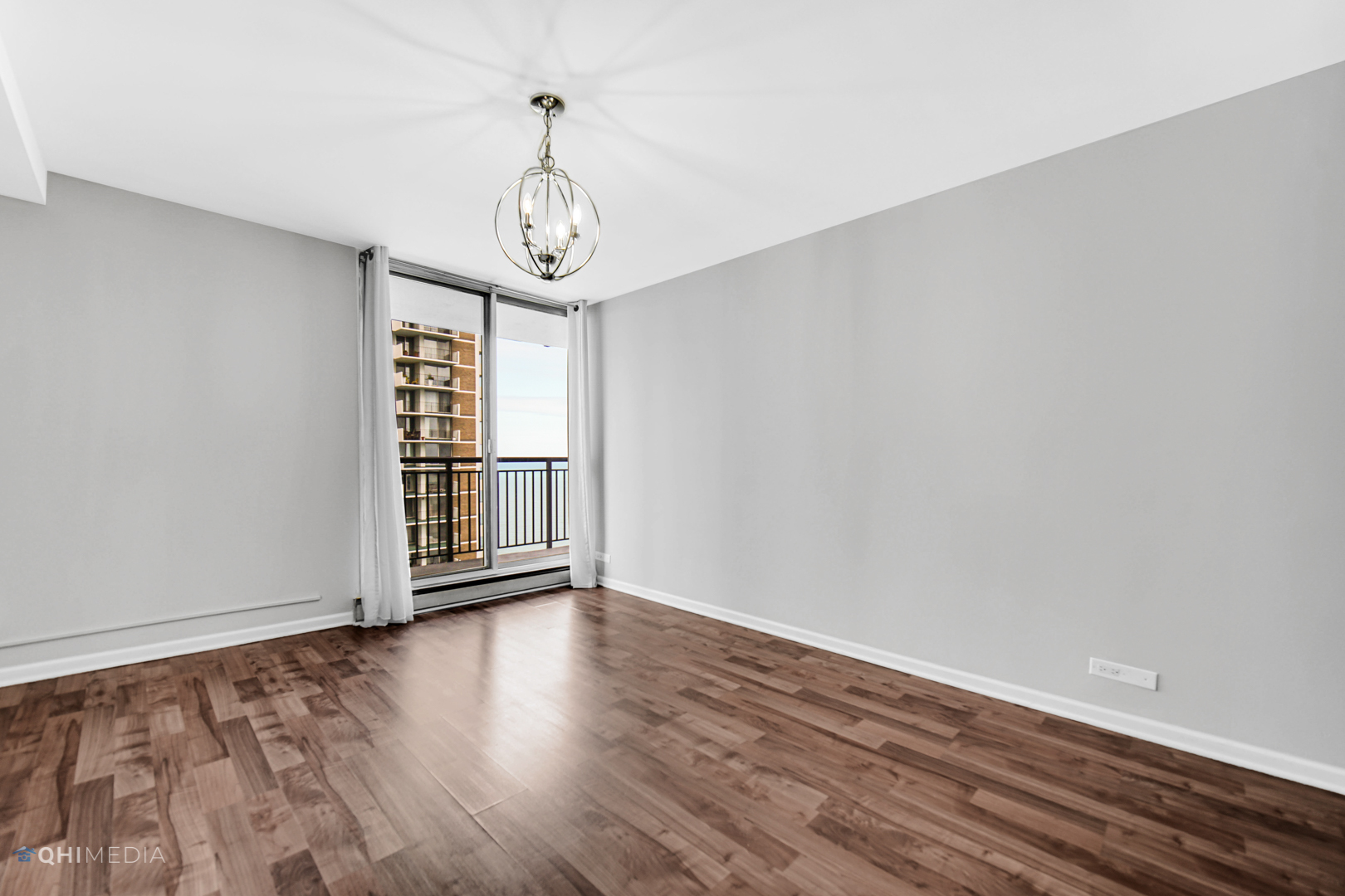 6007 North Sheridan Road, Unit 30D Chicago, IL 60660 - Photo 14 of 25 a view of an empty room with wooden floor and a window