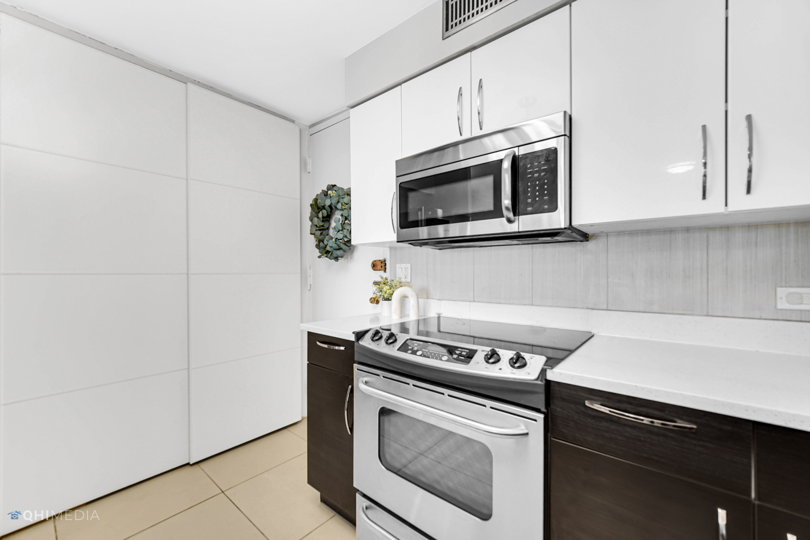 6007 North Sheridan Road, Unit 30D Chicago, IL 60660 - Photo 3 of 25 a kitchen with stainless steel appliances white cabinets and stove