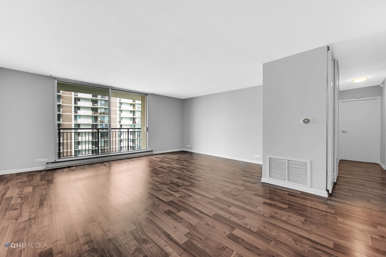 6007 North Sheridan Road, Unit 30D Chicago, IL 60660 - Photo 7 of 25 wooden floor in an empty room with a window