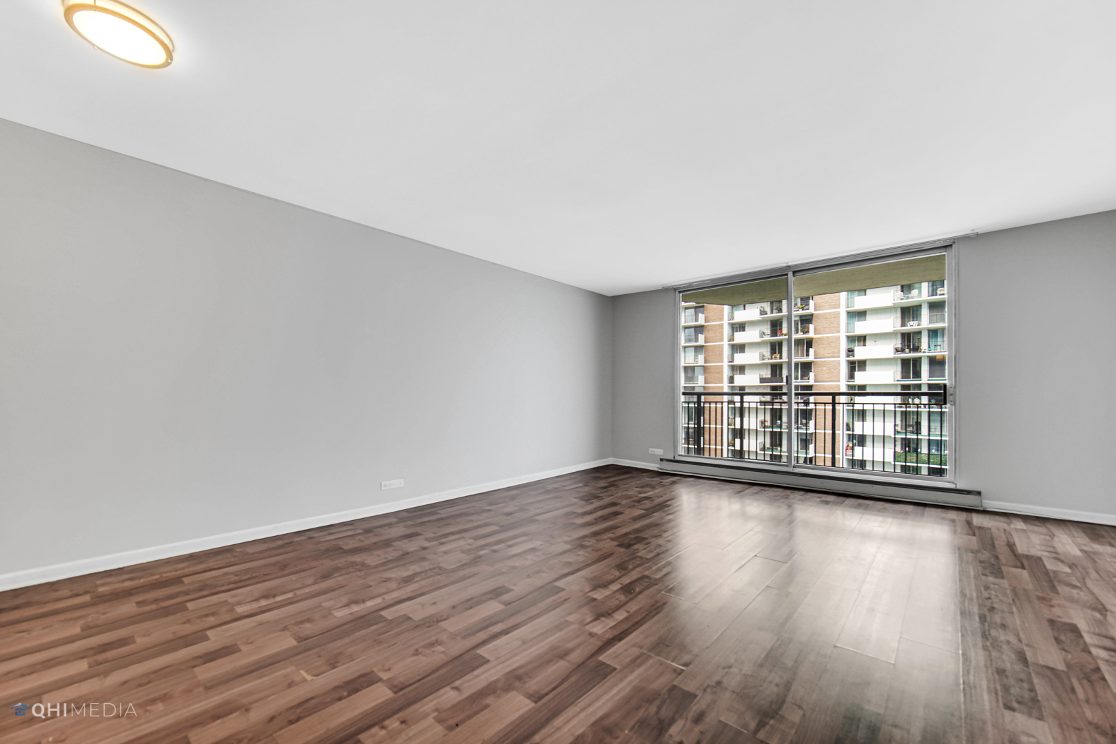 6007 North Sheridan Road, Unit 30D Chicago, IL 60660 - Photo 8 of 25 a view of an empty room with wooden floor and a window