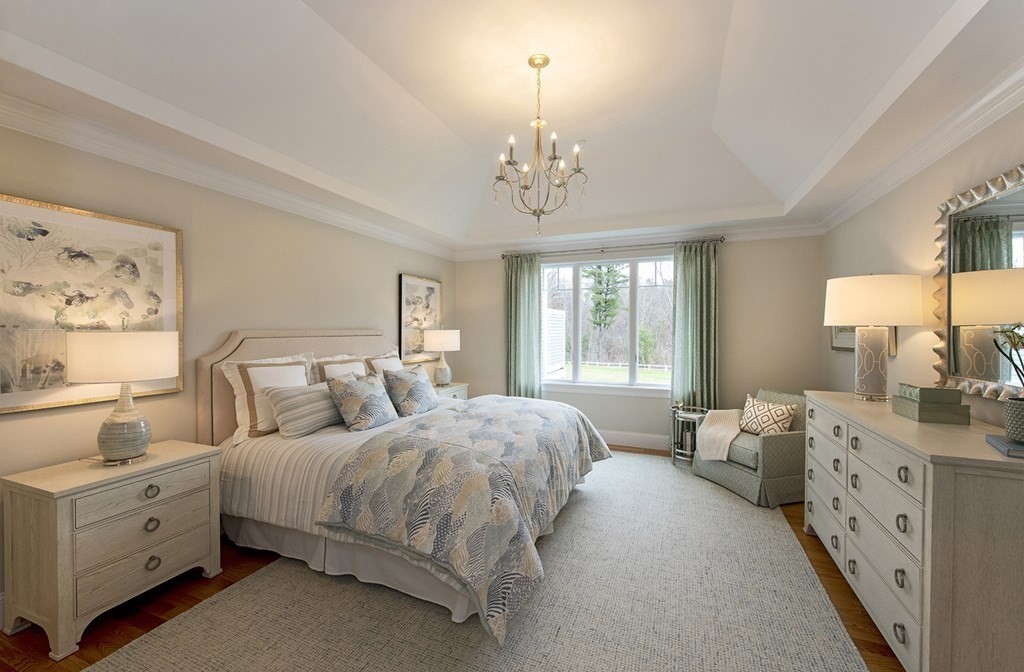 6 Robert Drive, Unit 23 Andover, MA 01810 - Photo 11 of 21 a bedroom with a bed and a chandelier