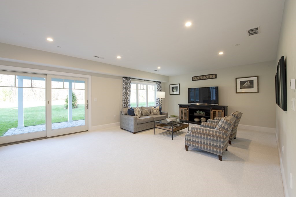 6 Robert Drive, Unit 23 Andover, MA 01810 - Photo 19 of 21 a living room with furniture and a flat screen tv