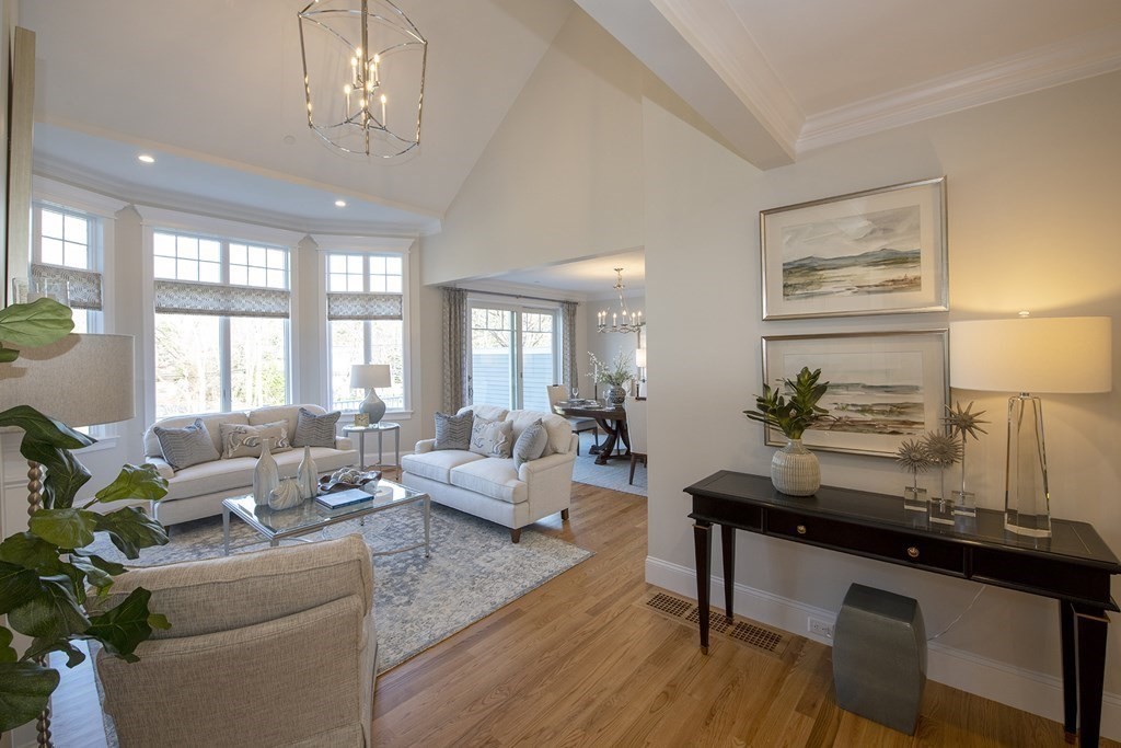6 Robert Drive, Unit 23 Andover, MA 01810 - Photo 2 of 21 a living room with furniture and a chandelier