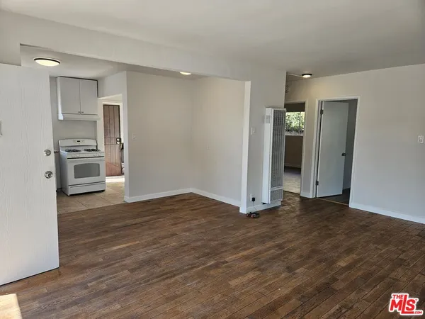 a view of a kitchen with a sink and a refrigerator