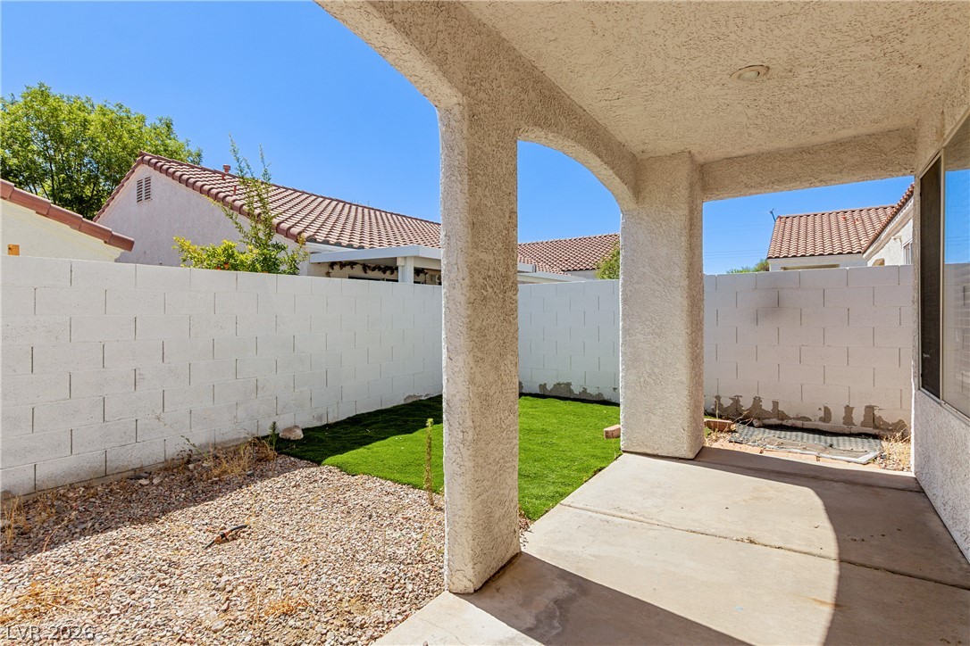 1815 Stablegate Avenue Henderson, NV 89012 - Photo 22 of 28 A private backyard oasis with low-maintenance landscaping and a covered patio for outdoor enjoyment.