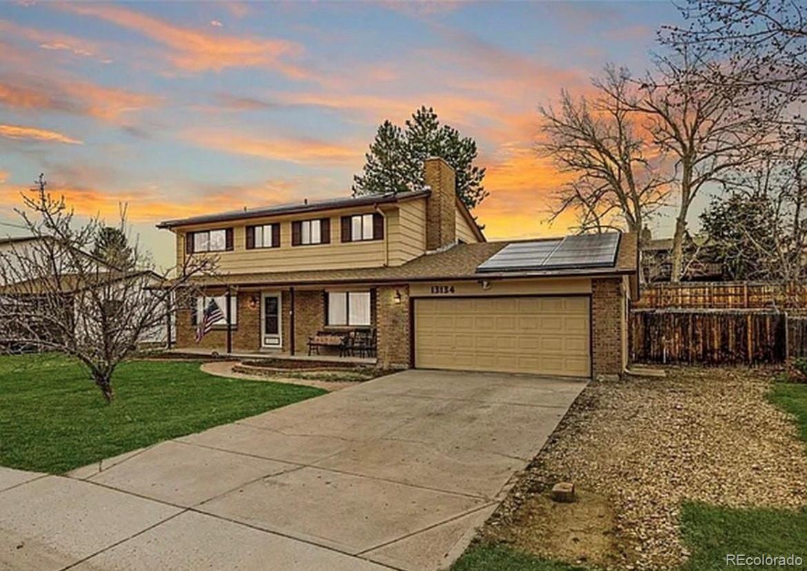 13134 Peacock Drive Lone Tree, CO 80124 - Photo 1 of 11 a front view of a house with yard and parking