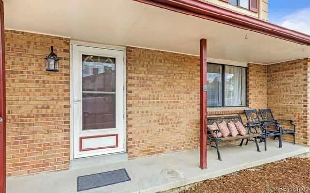 a view of front door of house with outdoor seating