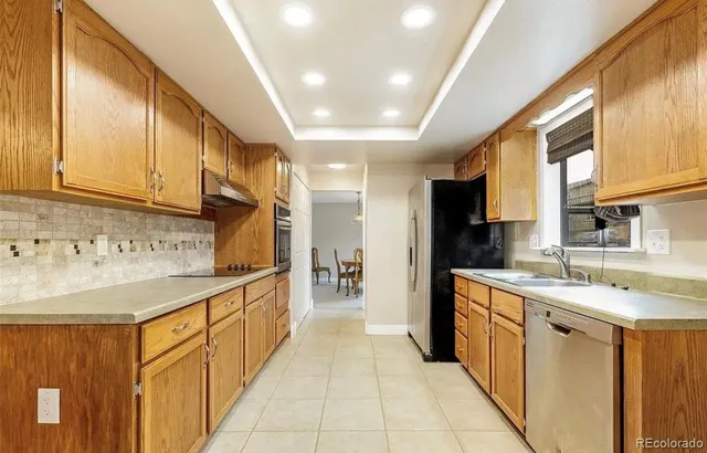 a kitchen with stainless steel appliances granite countertop a sink and cabinets