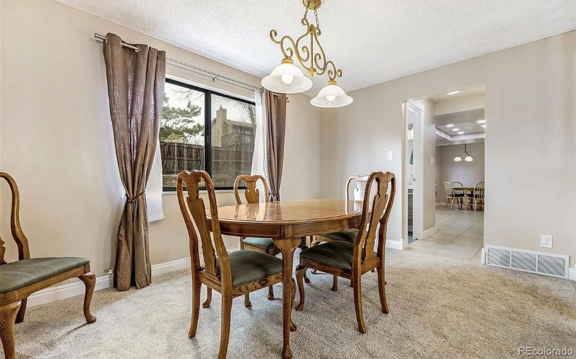 13134 Peacock Drive Lone Tree, CO 80124 - Photo 6 of 11 a view of a dining room with furniture window and outside view