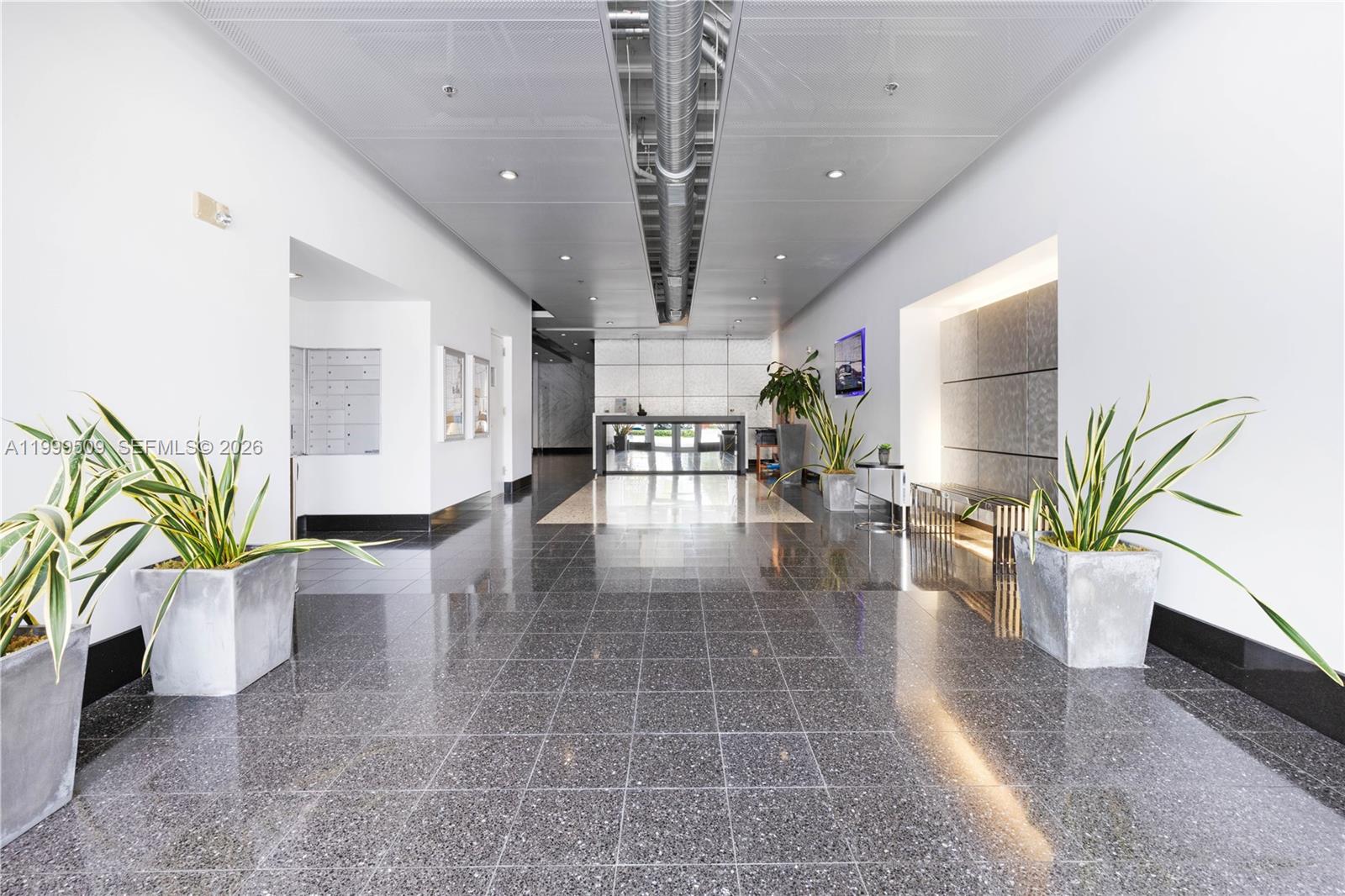 8101 Biscayne Boulevard, Unit R414 Miami, FL 33138 - Photo 19 of 27 a lobby with furniture and potted plant