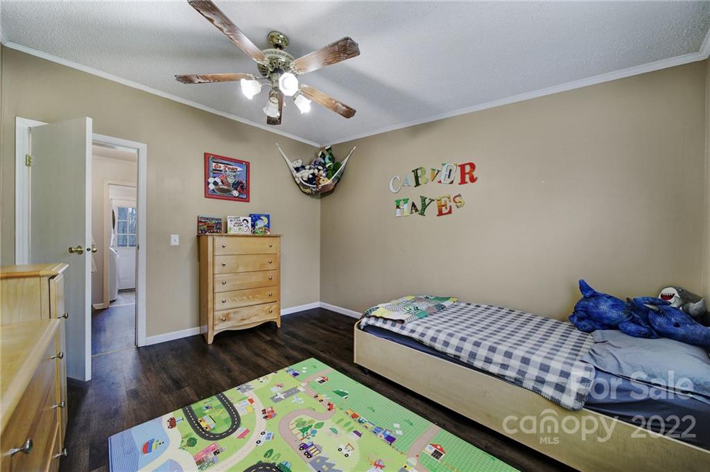 141 Old Hearth Road Clover, SC 29710 - Photo 13 of 29 a bedroom with a bed and wooden floor