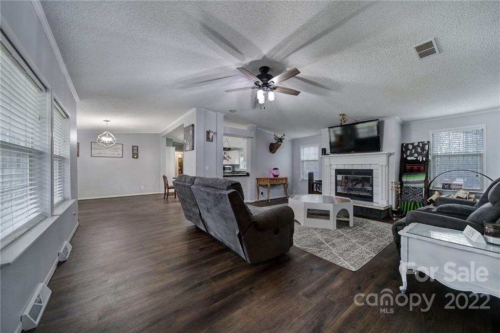 141 Old Hearth Road Clover, SC 29710 - Photo 2 of 29 a living room with furniture a fireplace and a flat screen tv