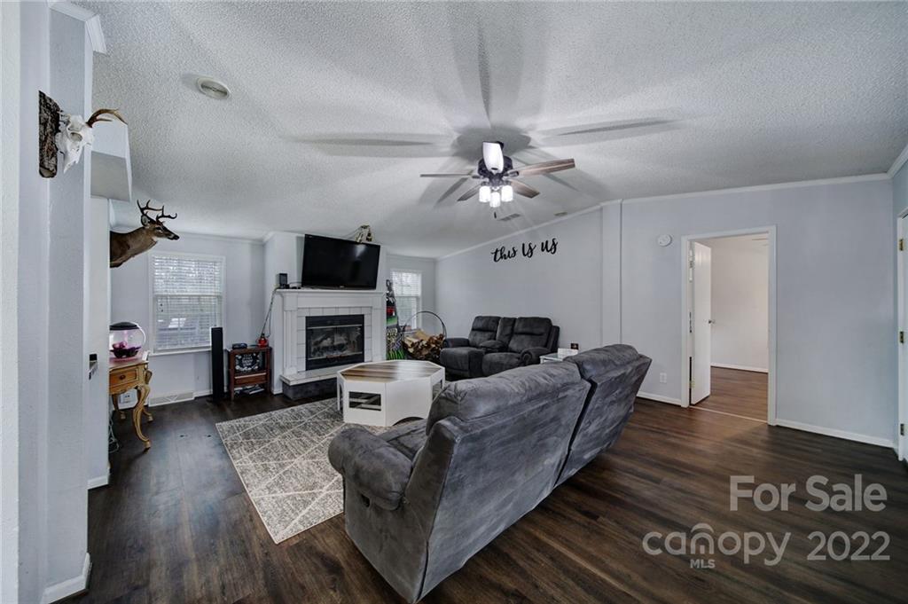 141 Old Hearth Road Clover, SC 29710 - Photo 3 of 29 a living room with furniture fireplace and a flat screen tv