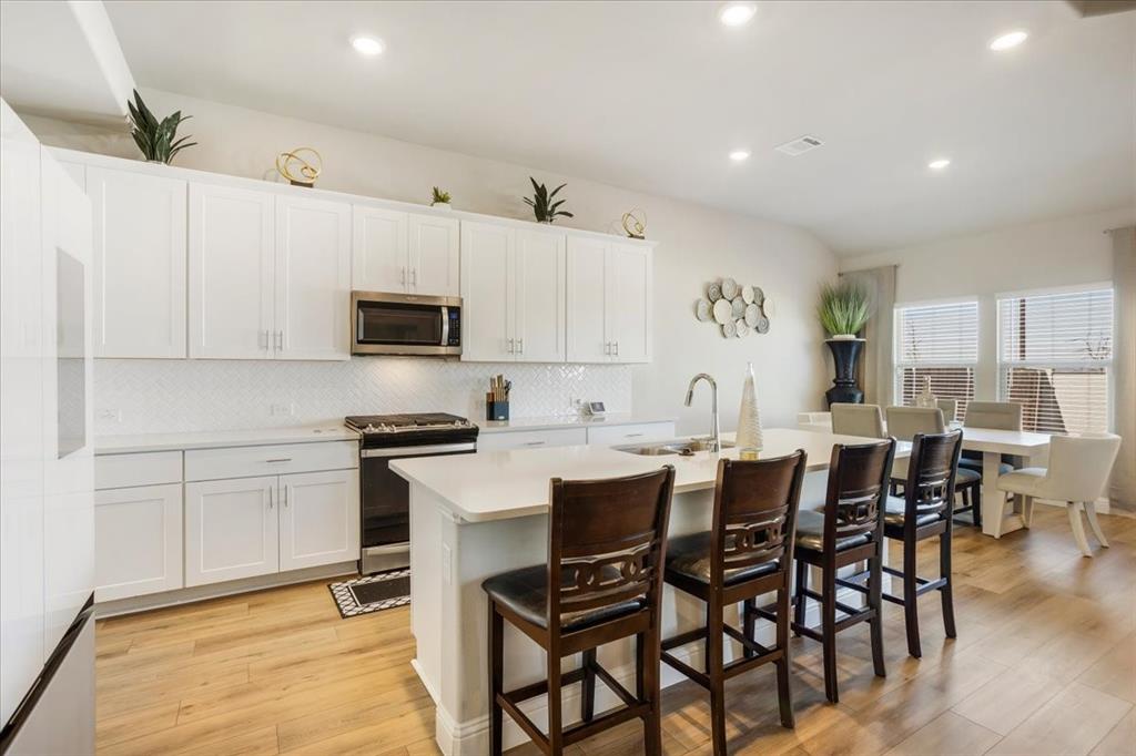 3806 Richland Drive Farmersville, TX 75442 - Photo 6 of 25 a kitchen with stainless steel appliances a table chairs and a refrigerator