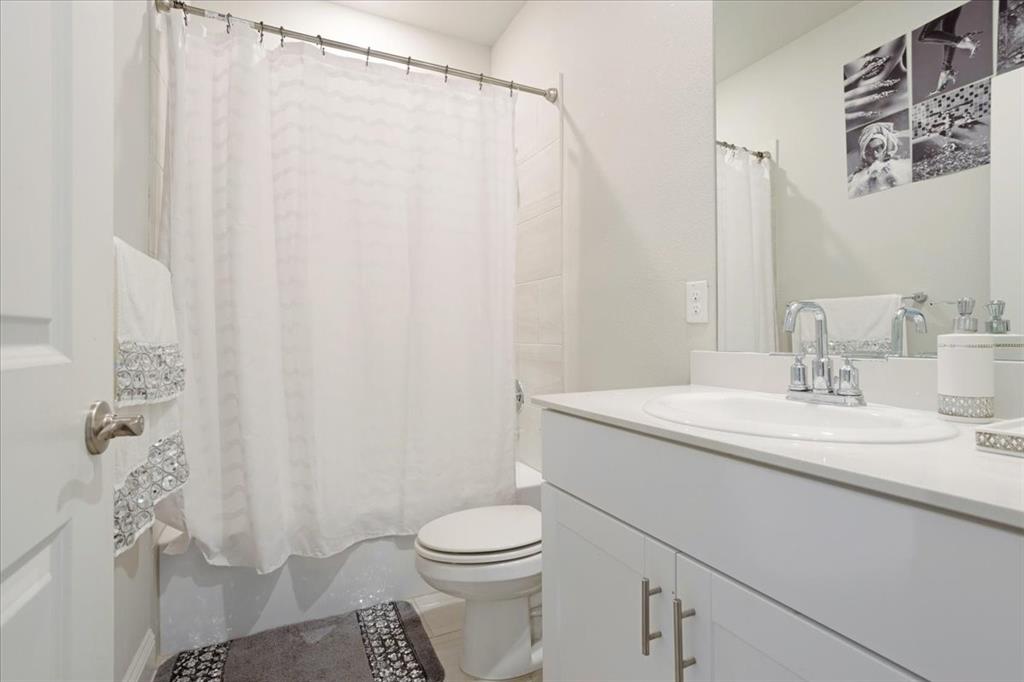 3806 Richland Drive Farmersville, TX 75442 - Photo 10 of 25 a bathroom with a sink a toilet and shower curtain