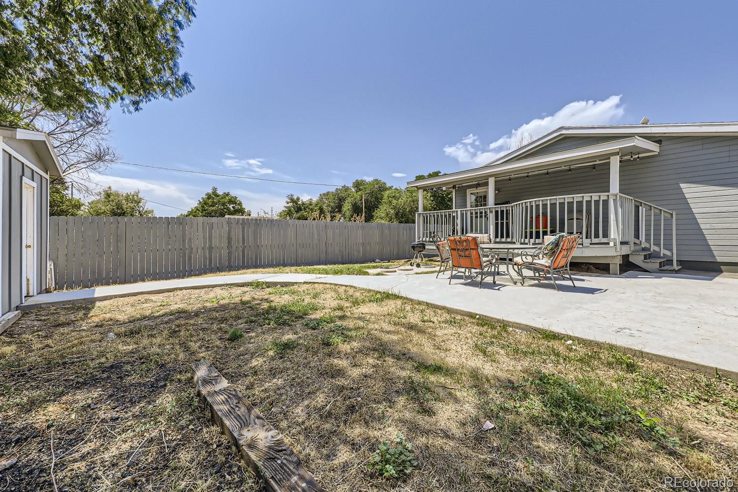 11682 Frederick Street Fort Lupton, CO 80621 - Photo 11 of 11 a swimming pool with outdoor seating and yard