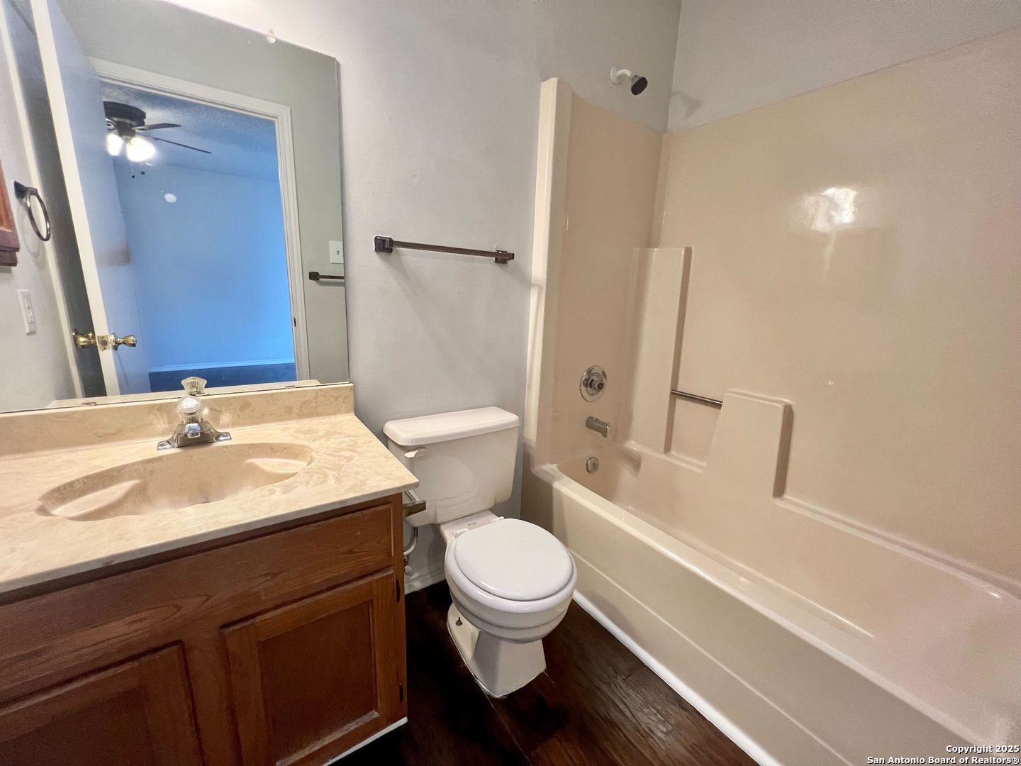 4545 Hoeneke Drive, Unit 103 Kirby, TX 78219 - Photo 14 of 19 a bathroom with a sink a toilet a mirror and shower