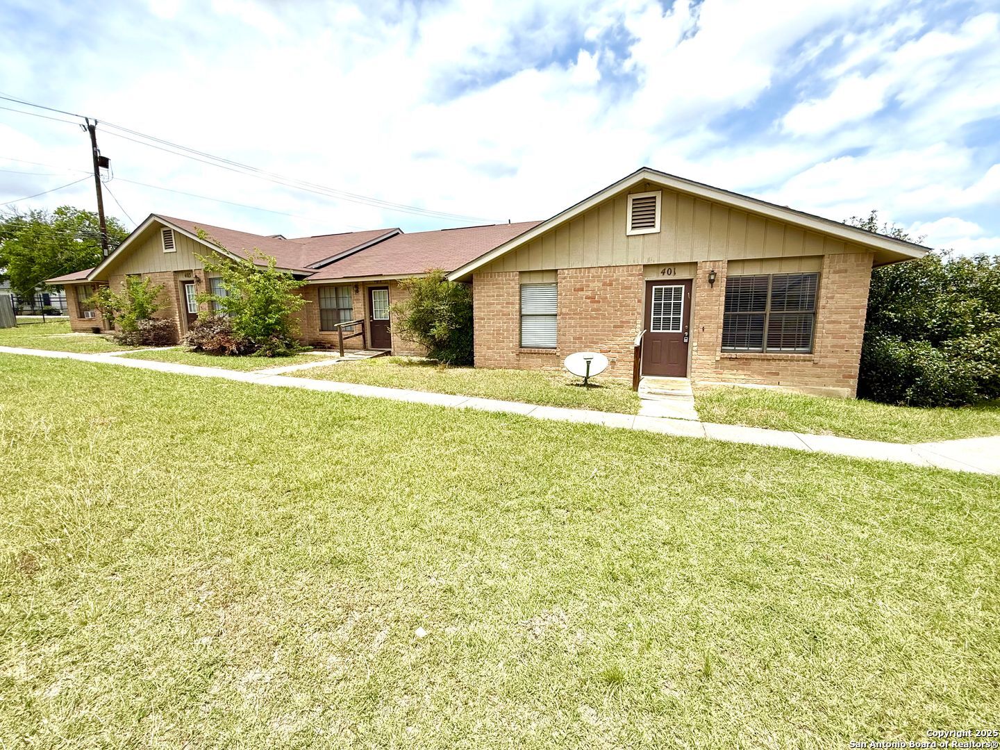 4545 Hoeneke Drive, Unit 103 Kirby, TX 78219 - Photo 2 of 19 a front view of house with yard and green space
